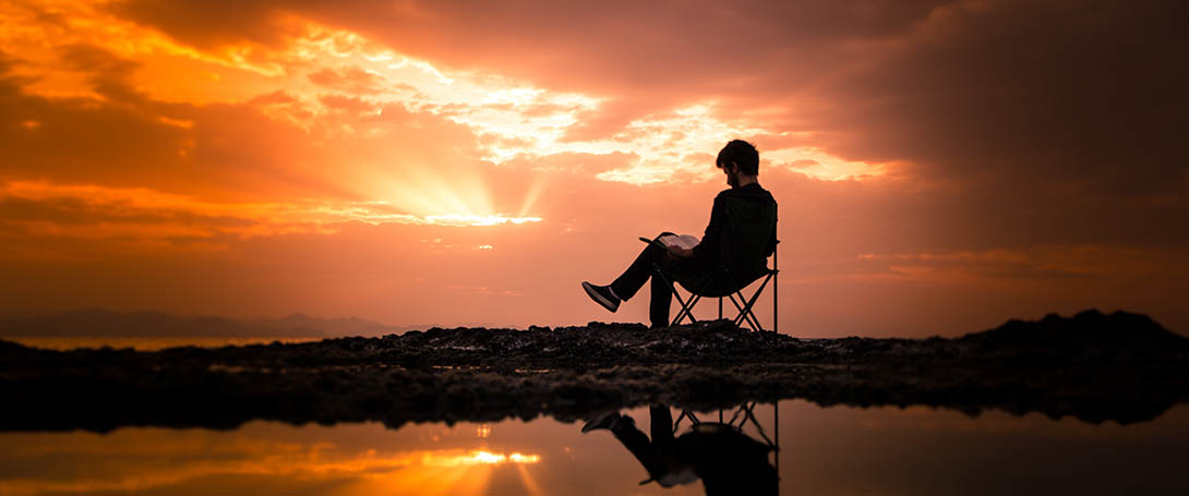 Person reading at sunset